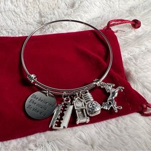 Charm bracelet including boxing gloves that says burden of peace